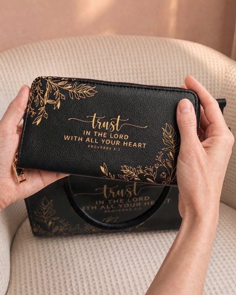 Hands holding the Trust wallet in front of the handbag