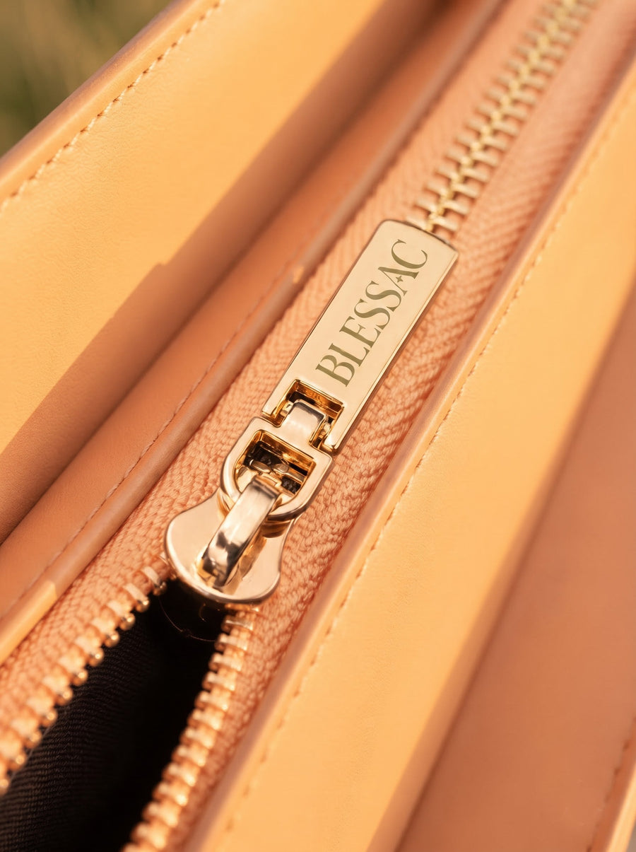 Gold Blessac-stamped zipper close-up