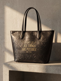 Blessac embossed leather tote in sable black — lifestyle shot in warm sunlight