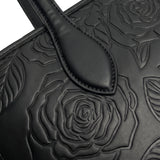 Close-up of tone-on-tone embossed rose florals on sable black vegan leather