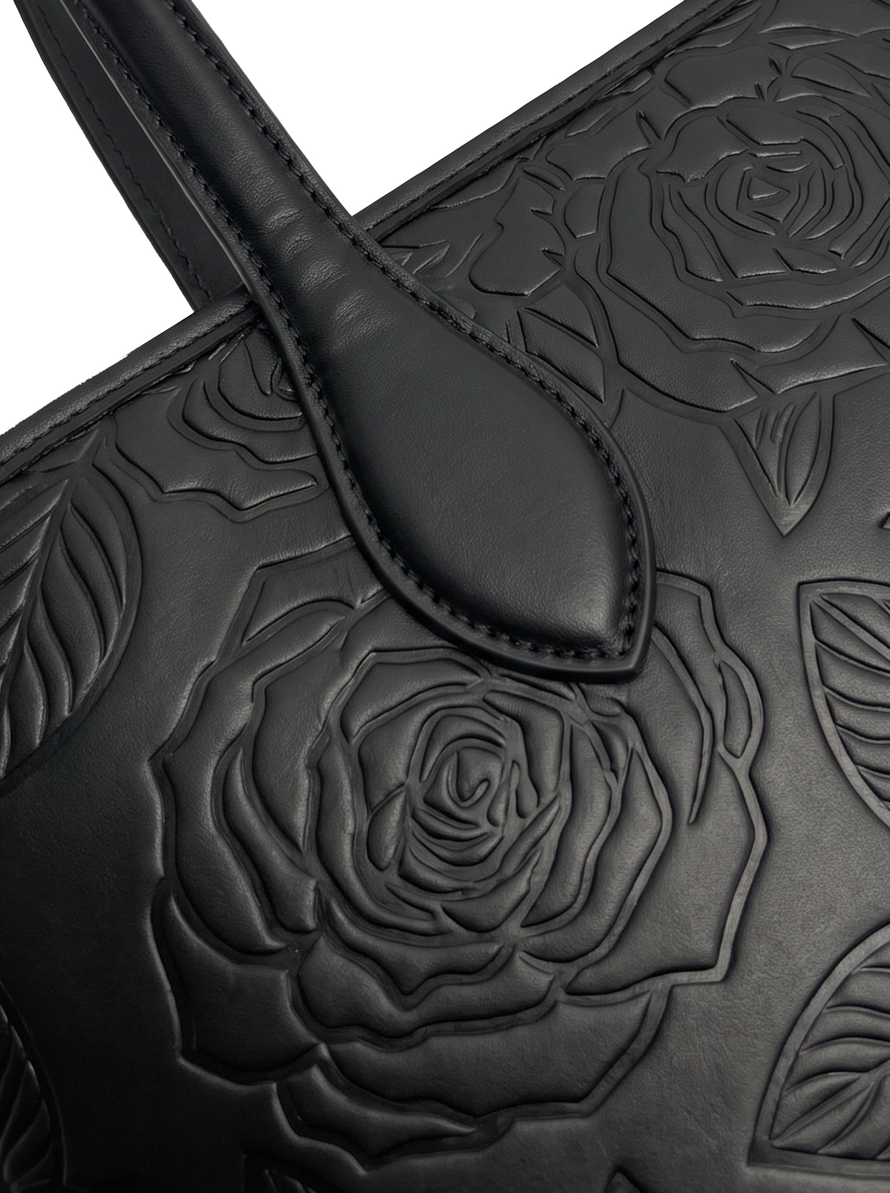 Close-up of tone-on-tone embossed rose florals on sable black vegan leather