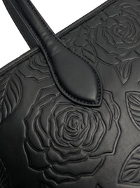 Close-up of tone-on-tone embossed rose florals on sable black vegan leather