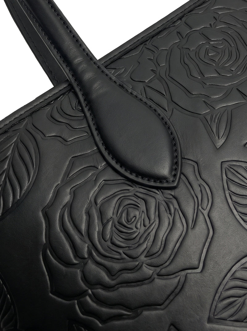 Close-up of tone-on-tone embossed rose florals on sable black vegan leather