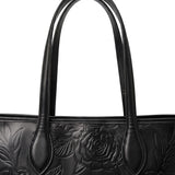 Double shoulder straps of the sable black embossed leather tote