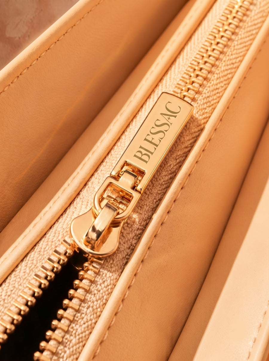 Gold Blessac-stamped zipper close-up