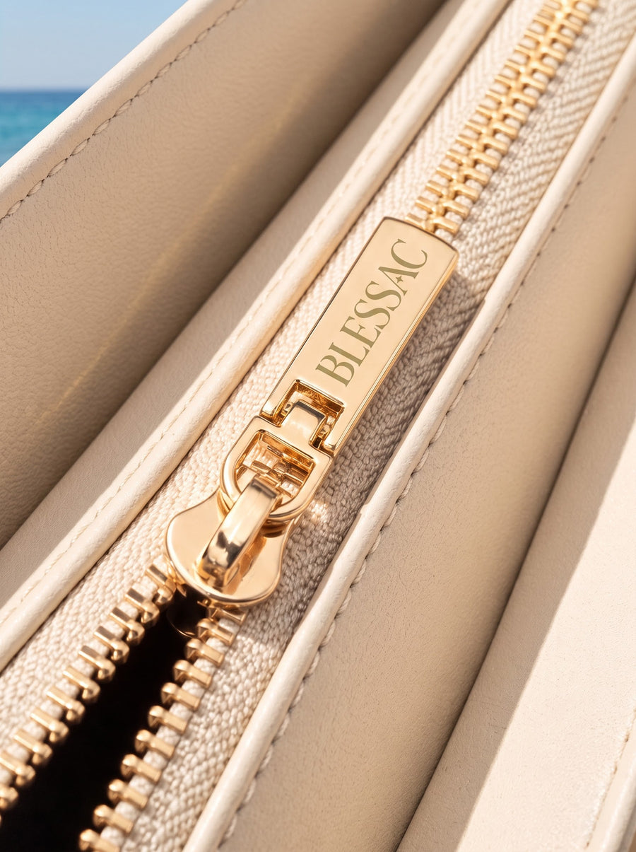Gold Blessac-stamped zipper close-up